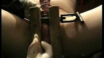 Dirty slave tied in a dungeon gets his balls squeezed by milf mistress bdsm